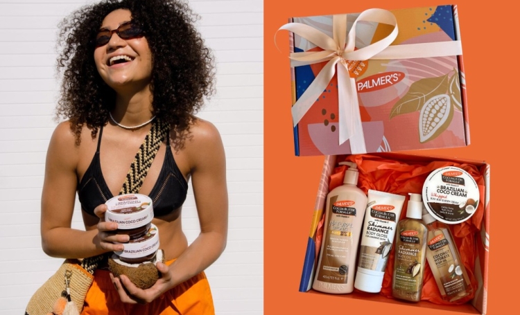 A woman is outdoors smiling whilst holding a stack of Brazilian Coco Cream next to an image of Palmer's limited-edition Summer Skin Christmas Bundle